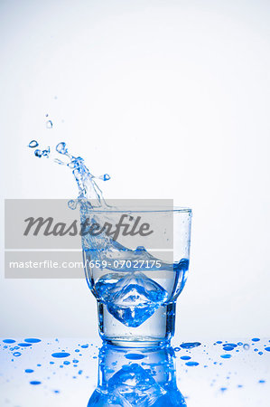Water splashing out of glass Water splashing out of glass