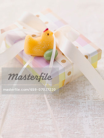 An Easter parcel with a fondant chick and a sugar egg
