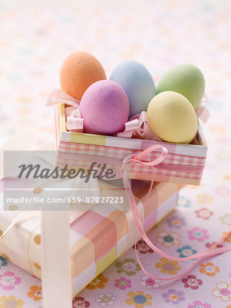 An Easter parcel and brightly coloured eggs for Easter