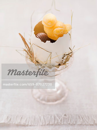 An Easter nest in an eggcup with sweets