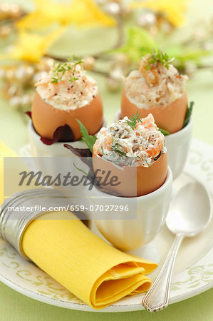 Assorted filled eggshells: with celery and walnuts, with carrots and horseradish, and with salmon