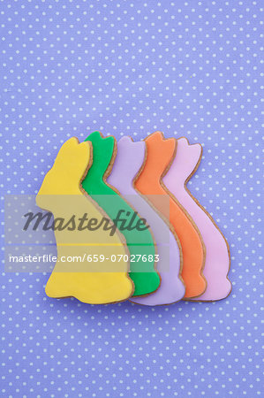 A row of shortbread Easter rabbits with colourful icing A row of shortbread Easter rabbits with colourful icing