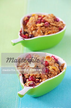 Individual cranberry crumble with almonds in pear-shaped dishes
