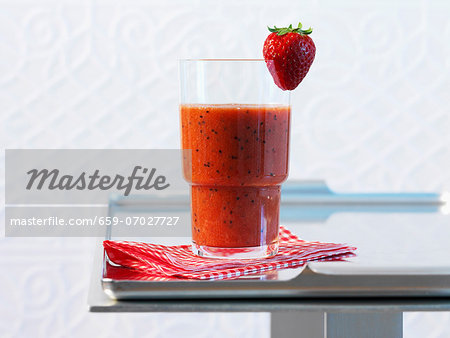 A glass of strawberry and kiwi smoothie