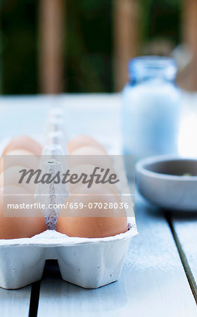 Fresh Eggs in a Carton on an Outdoor Table