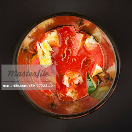 Mixed vegetables, tomato sauce and diced bread (for gazpacho) in a blender