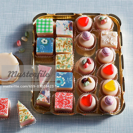 Colourful petits fours on a gold tray Colourful petits fours on a gold tray