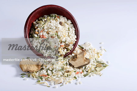 Vialone Nano risotto rice with dried porcini mushrooms, carrots, leek, celery, chives, tomatoes and peppers with a ceramic dish Vialone Nano risotto rice with dried porcini mushrooms, carrots, leek, celery, chives, tomatoes and peppers with a ceramic dish