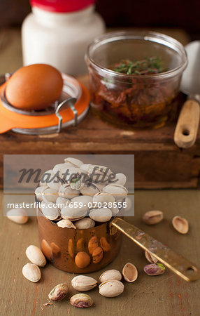 Pistachios in a Measuring Cup with Egg and Sun Dried Tomatoes in Background