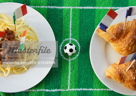 Spaghetti (Italy) and croissants (France) with football-themed decoration