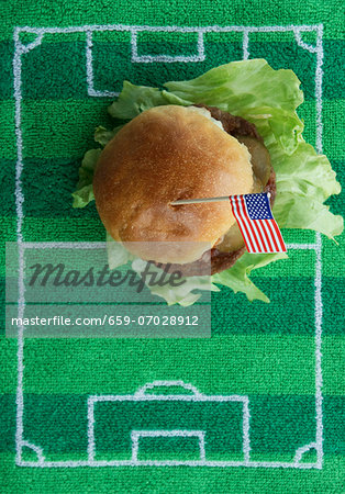 Hamburger with a US flag on a football-field mat