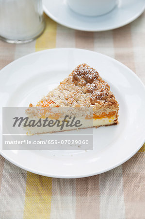 A slice of cheesecake with Mirabelle plums and crumble