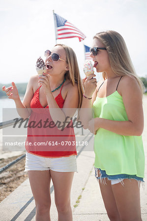 Young women eating ice cream at beach