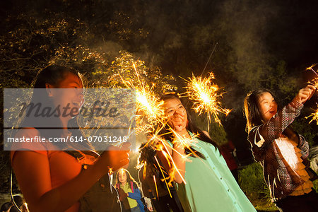 Girls with sparklers at night