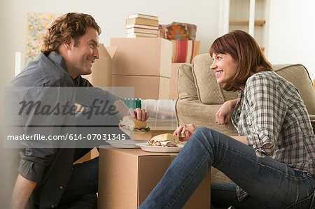 Couple having lunch break whilst moving