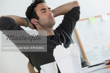 Portrait of male listening to earphones