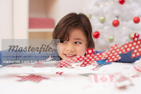 Girl holding Christmas decoration, smiling