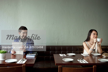 Young man looking at young woman in restaurant