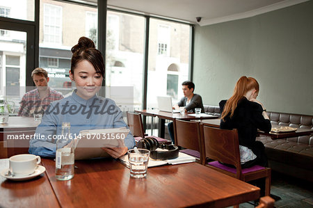 Young woman with digital tablet in cafe