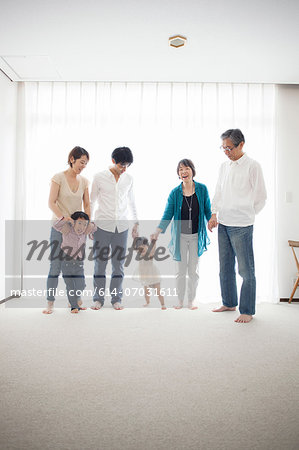 Three generation family holding hands, portrait