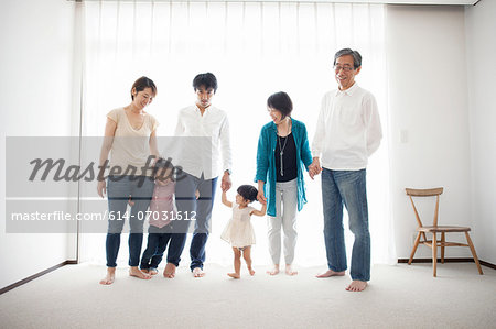 Three generation family holding hands, portrait