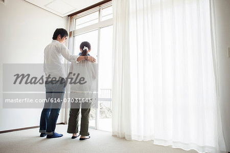 Couple standing by window