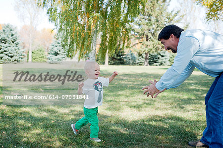 Grandfather playing with grandson in park