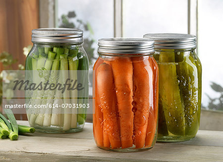 Three jars of pickled vegetables on windowsill Three jars of pickled vegetables on windowsill