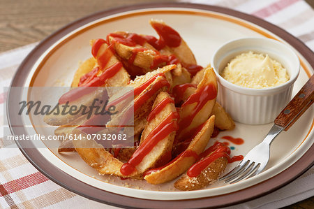 Still life of plate with chips covered in tomato sauce