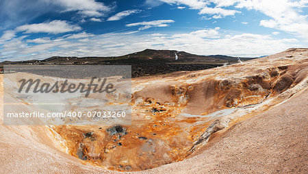 Leirhnjukur is the hot geothermal pool at Krafla area, Iceland. The area around the lake is multicolored and cracked.