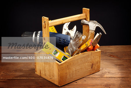 wooden tool box at work on a black background