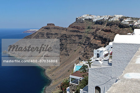 Firostefani on the edge of the volcanic caldera. The ruins of Skaros on the left and Oia in the background.