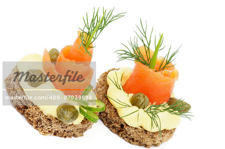 Snacks with Smoked Salmon, Greens, Cheese Cream and Capers isolated on white background