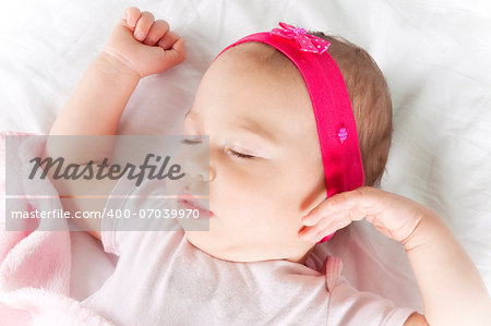 Little and cute baby sleeping on the bed