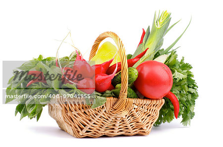 Vegetable Basket with Radish, Basil, Chili Pepper, Bell Pepper, Cucumbers, Leek, Parsley and Tomato isolated on white background