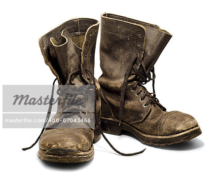 Old and dirty military boots isolated on white background