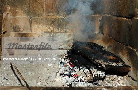 Fireplace with coal and a smoke