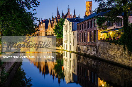 Water canal, medieval houses and bell tower at night, Bruges
