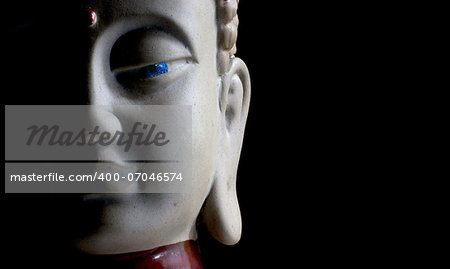 Buddha face with stone eye e black background