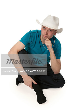 man in a cowboy hat sitting in the lotus position isolated on a white background