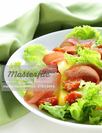 fresh green snack salad with ham and vegetables