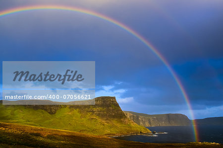 Rainbow over a dramatic coast of Scottish highlands, Isle of Skye, United Kingdom