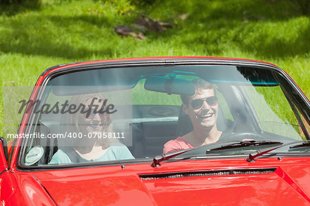 Happy young couple going for a ride together on a sunny day