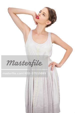Sensual model in white dress posing looking away on white background