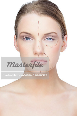 Calm pretty blonde with dotted lines on the face before surgery