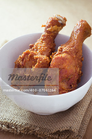 Fresh fried chicken on a white chalice set on a sackcloth
