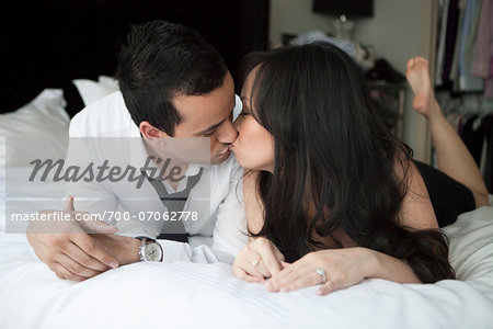 Close-up of couple in bed, kissing