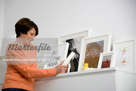 Senior woman looking at family photographs Senior woman looking at family photographs