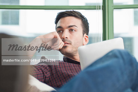 Close up of young man at home with digital tablet