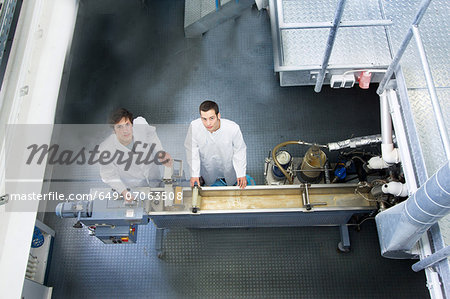 Elevated view of two technicians in working laboratory Elevated view of two technicians in working laboratory